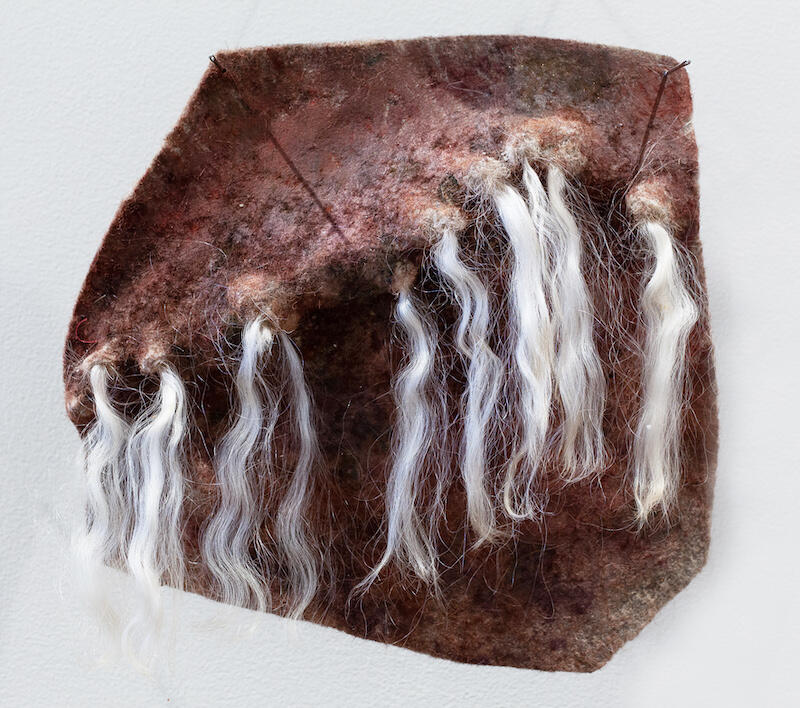 Felt wall sculpture with horse hair hanging protruding
